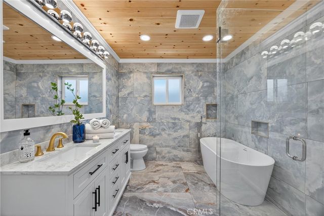 a spacious bathroom with a double vanity sink a mirror and a bathtub