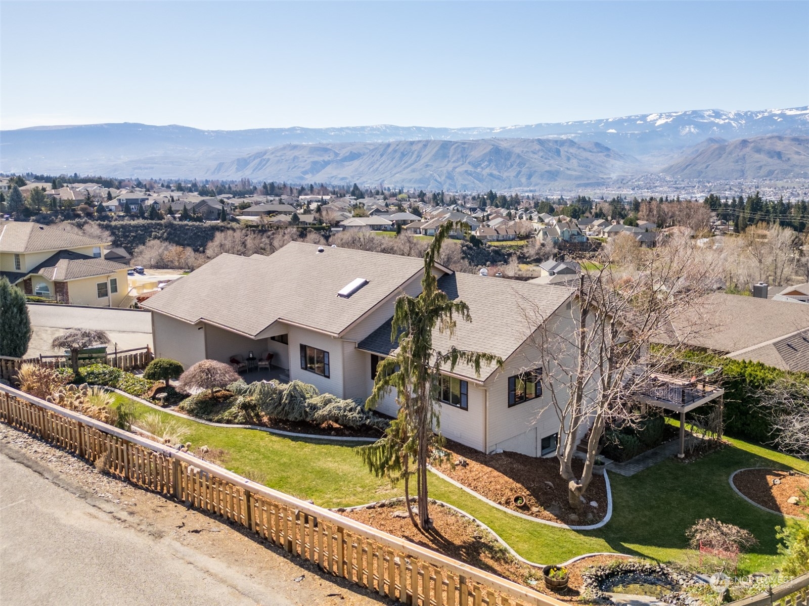 an aerial view of residential houses with outdoor space and mountain view