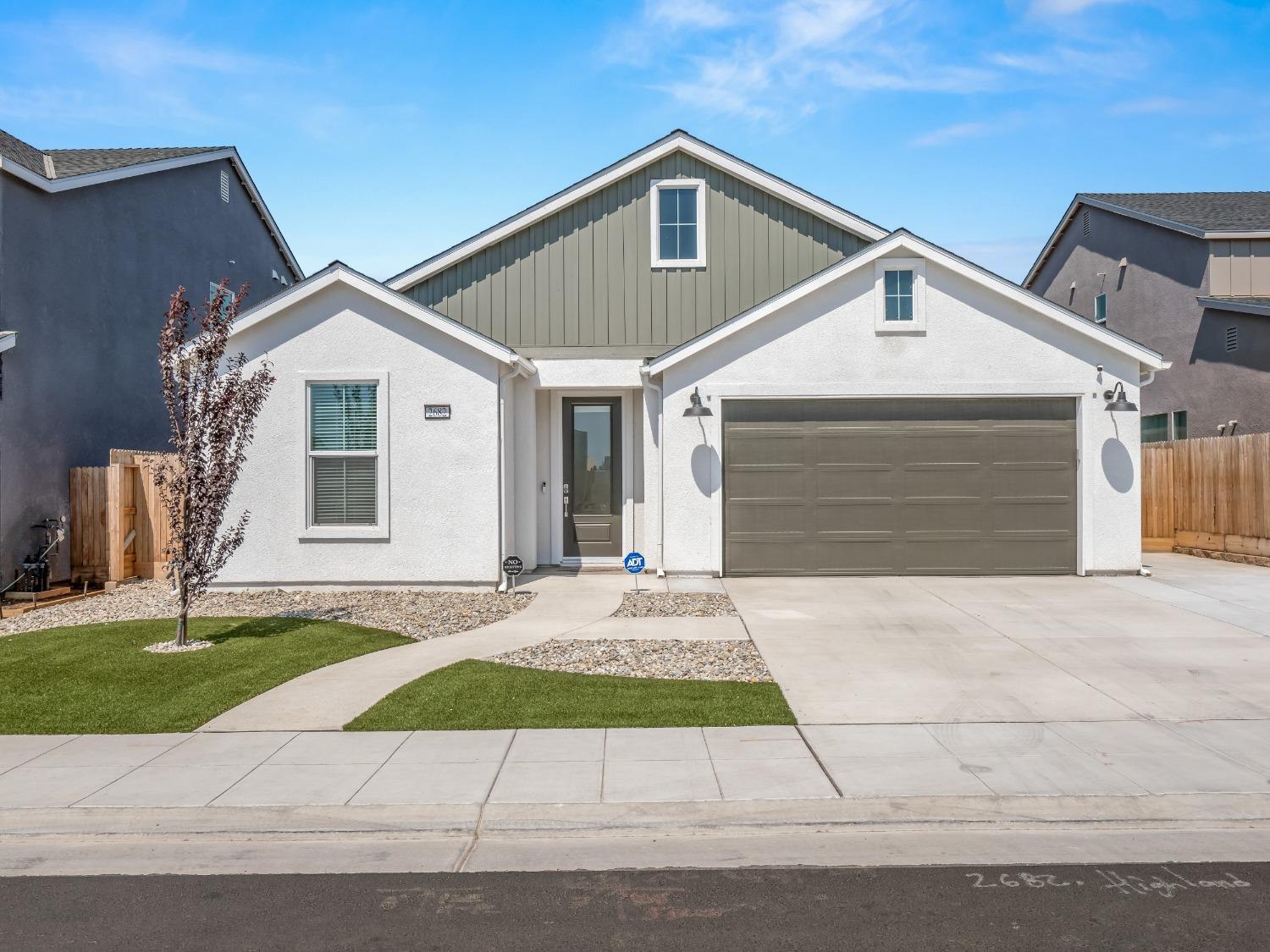 2682 Highland Avenue Clovis, CA 93619 - Photo 1 of 29 a front view of a house with a yard and garage