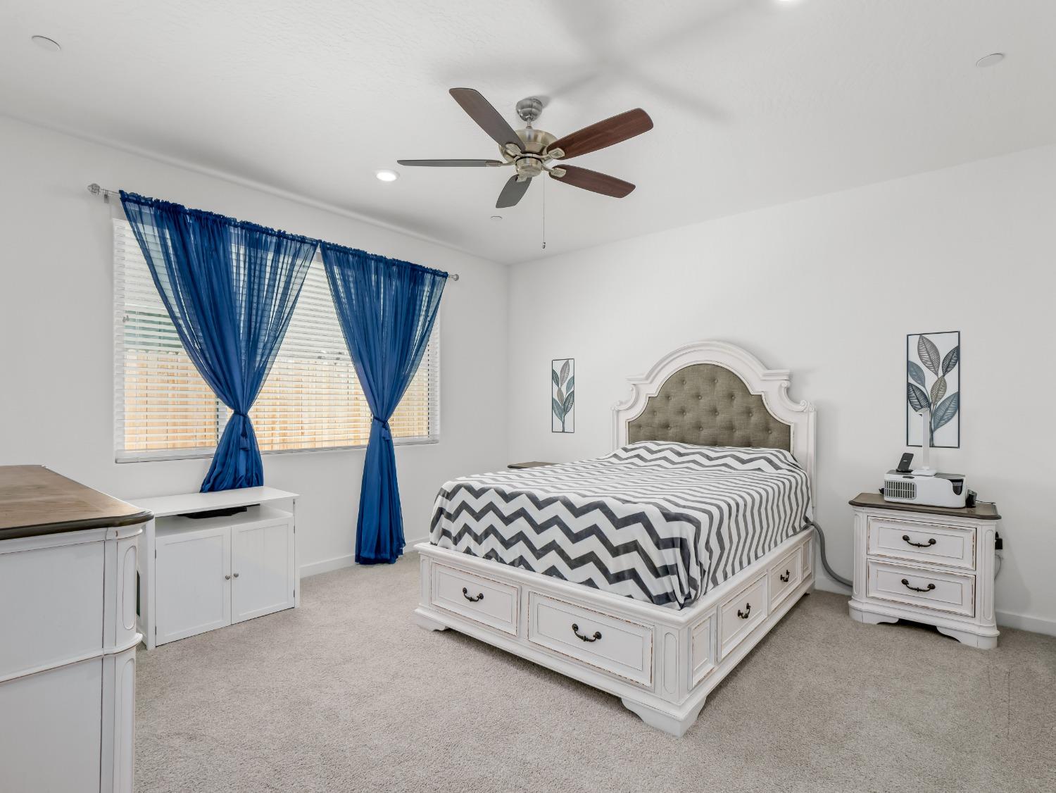 2682 Highland Avenue Clovis, CA 93619 - Photo 19 of 29 a bedroom with a bed a window and dresser