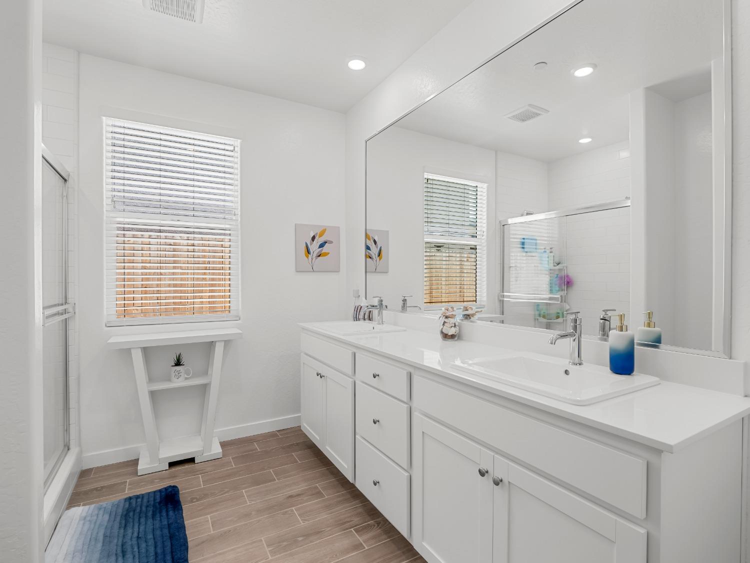 2682 Highland Avenue Clovis, CA 93619 - Photo 20 of 29 a spacious bathroom with double vanity a mirror and a shower