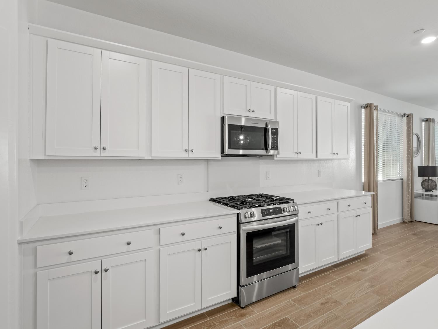 2682 Highland Avenue Clovis, CA 93619 - Photo 6 of 29 a kitchen with white cabinets and appliances