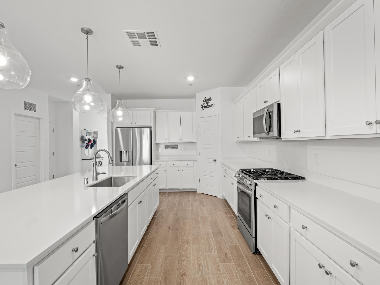 2682 Highland Avenue Clovis, CA 93619 - Photo 7 of 29 a large kitchen with cabinets and wooden floor