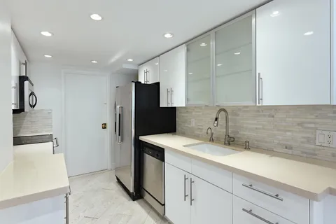 a kitchen with cabinets and white appliances
