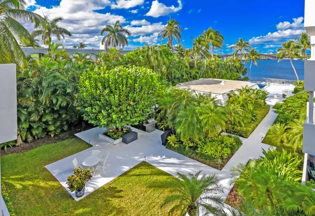 a living room with furniture and a dining table with chairs