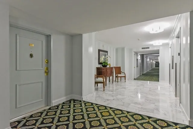 a view of a dining room with furniture and potted plant