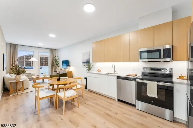 a kitchen with a sink cabinets and stainless steel appliances