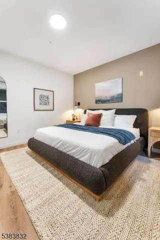 a bedroom with double bed and a couch