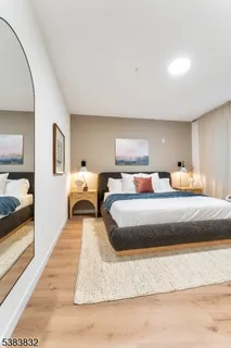 a bedroom with double bed and a large mirror