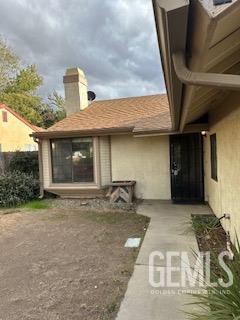 Undisclosed Address Tehachapi, CA 93561 - Photo 2 of 10 a front view of a house with a garden