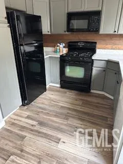 a kitchen with granite countertop stainless steel appliances and wooden cabinets