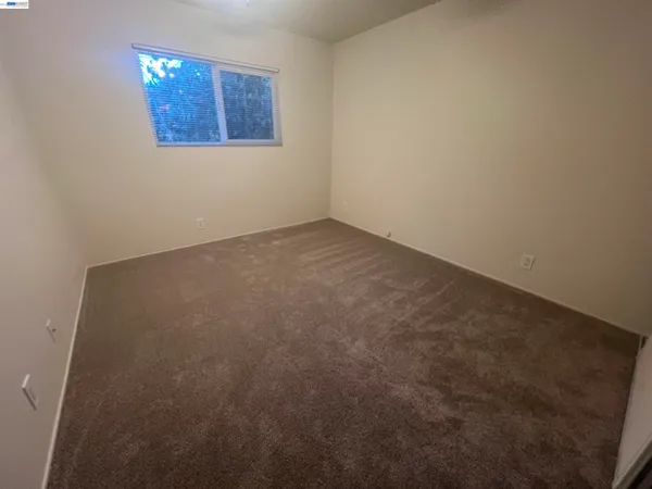 an empty room with a ceiling fan