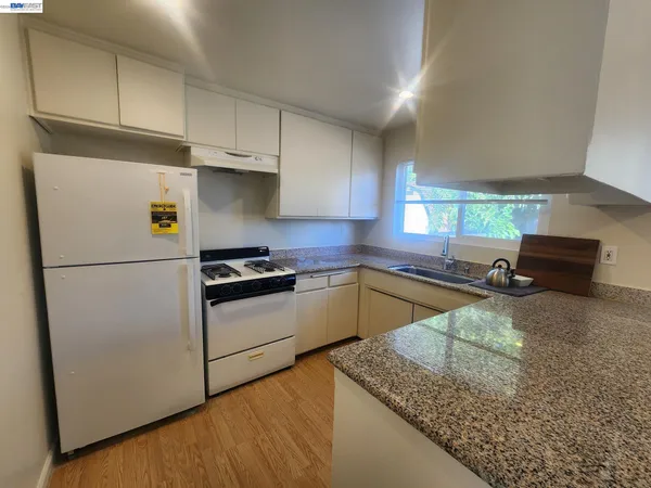 a kitchen with a refrigerator and a sink