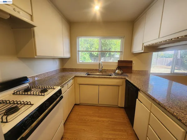 a kitchen with a stove a sink and a microwave
