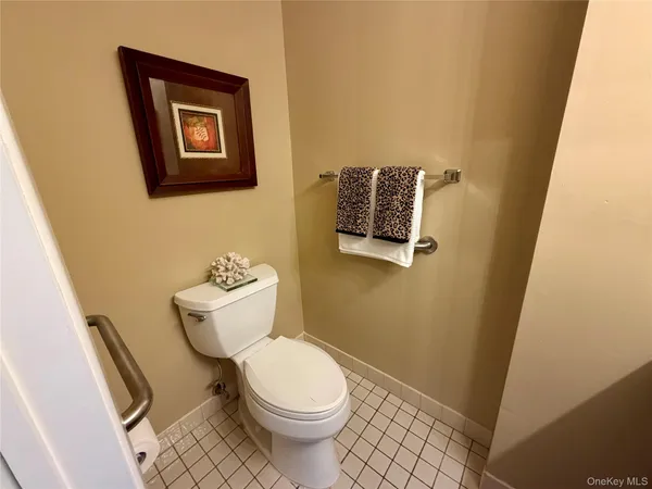 a white toilet sitting next to a small bathroom