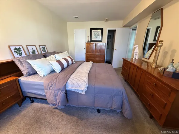 a bedroom with a bed and dresser