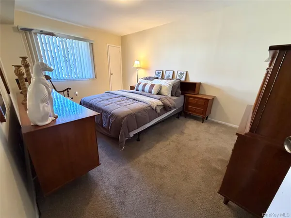 a bed room with a bed and a window