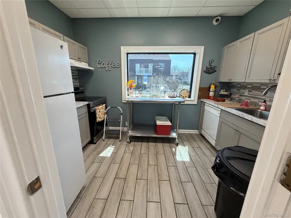 a kitchen with a refrigerator and a stove