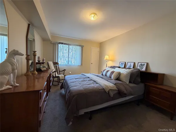 a bedroom with a bed a couch and dresser