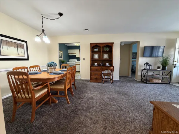 a dining room with furniture and window