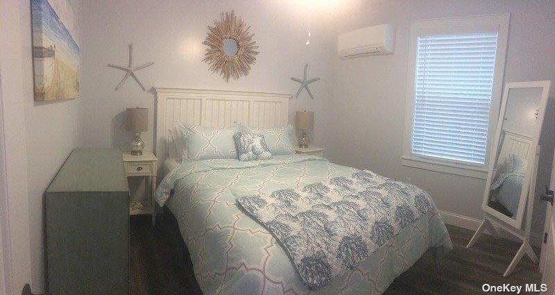 368 Surf Road Ocean Beach, NY 11770 - Photo 4 of 11 a bed sitting in a bedroom next to a window