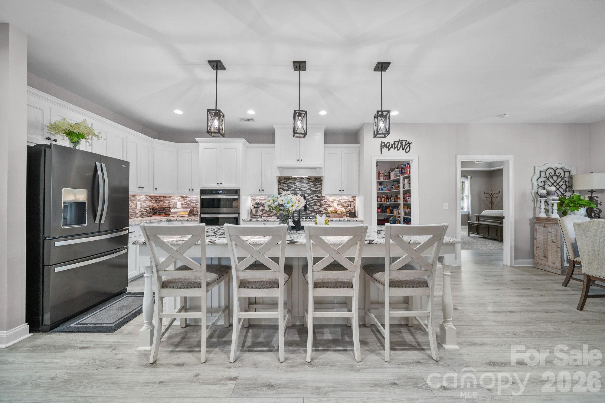617 Caudle Road Peachland, NC 28133 - Photo 13 of 48 a kitchen with stainless steel appliances kitchen island granite countertop a dining table chairs and granite counter tops