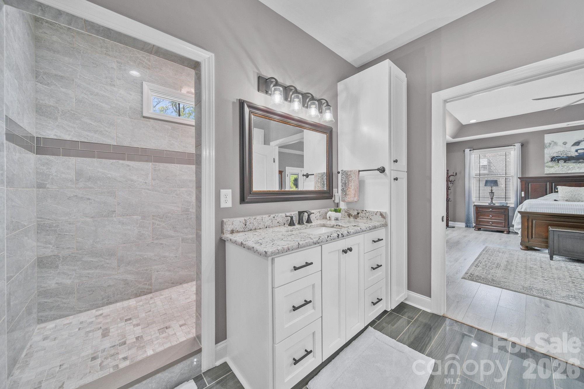 617 Caudle Road Peachland, NC 28133 - Photo 25 of 48 a bathroom with a granite countertop sink mirror and a bathtub
