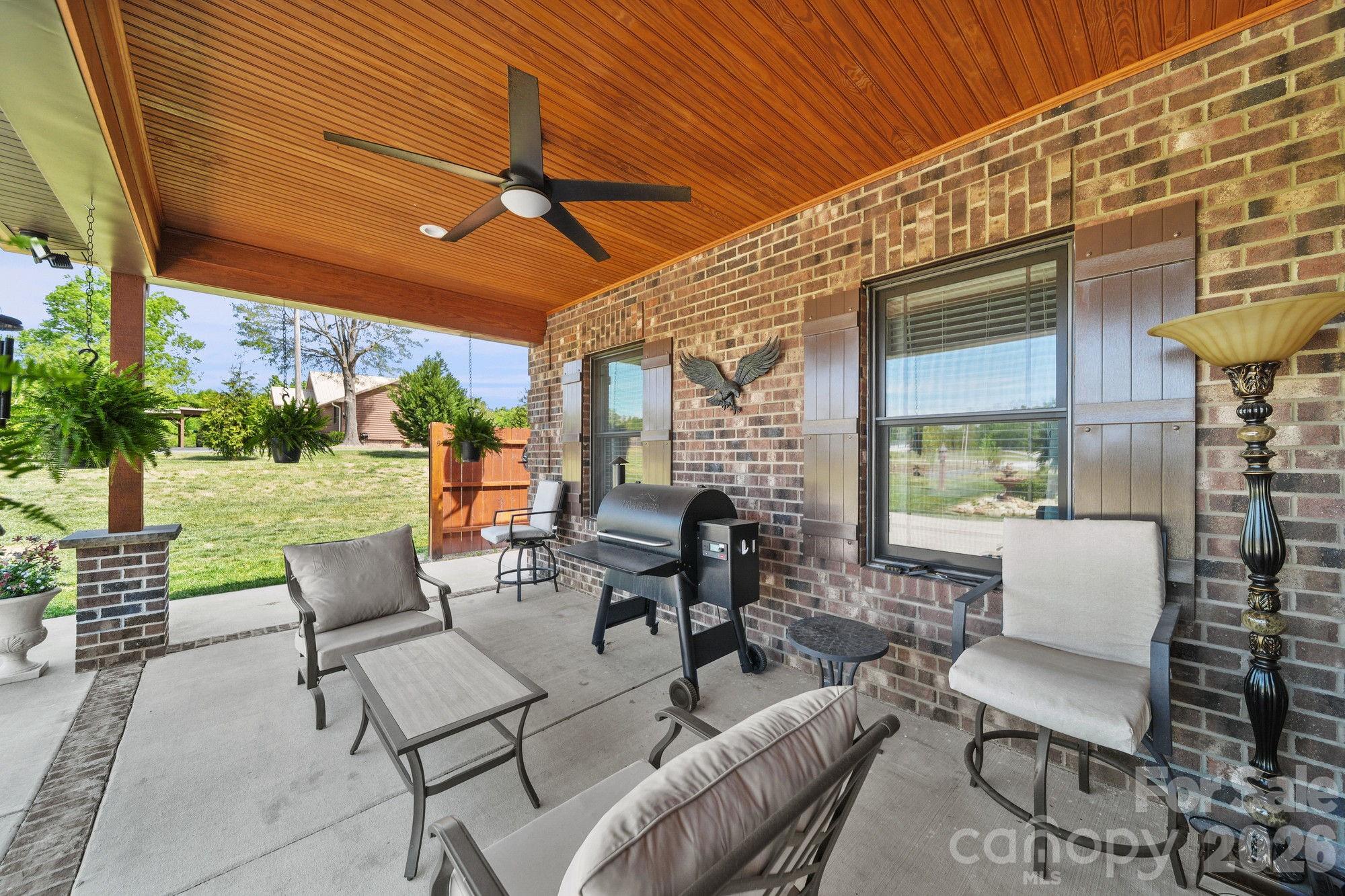 617 Caudle Road Peachland, NC 28133 - Photo 10 of 48 a view of a patio with couches chairs dining table and chairs with wooden floor
