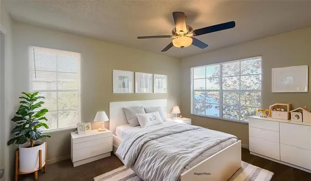 a bedroom with a balcony a bed and a chandelier