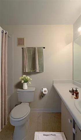 a bathroom with a toilet a sink and a mirror