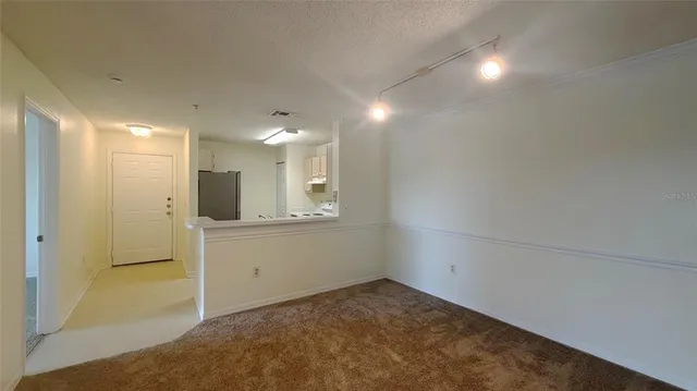 a view of a kitchen with white cabinets