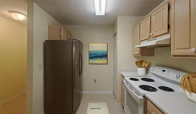 a kitchen with a stove and a refrigerator