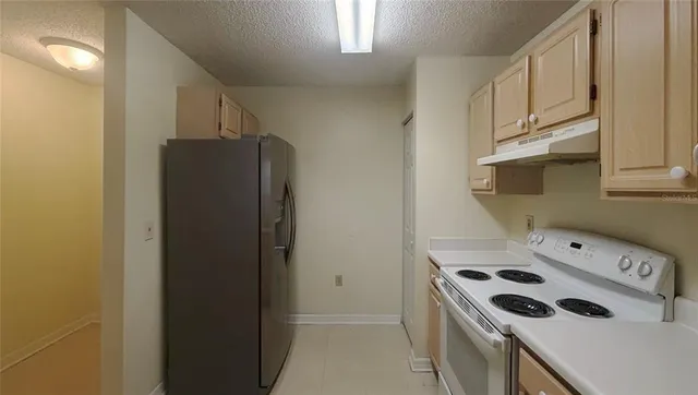 a kitchen with a stove and a refrigerator