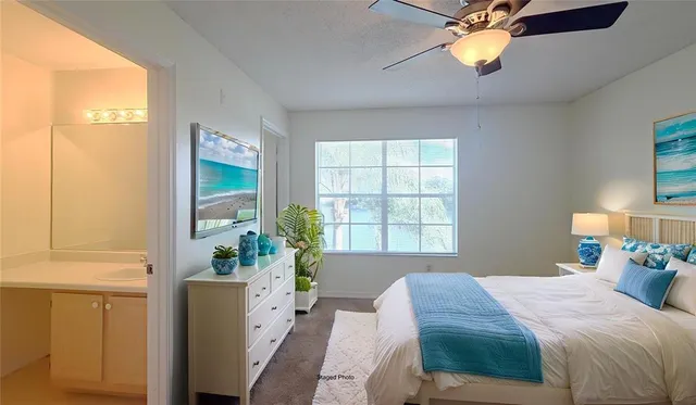 a bedroom with a bed and a potted plant