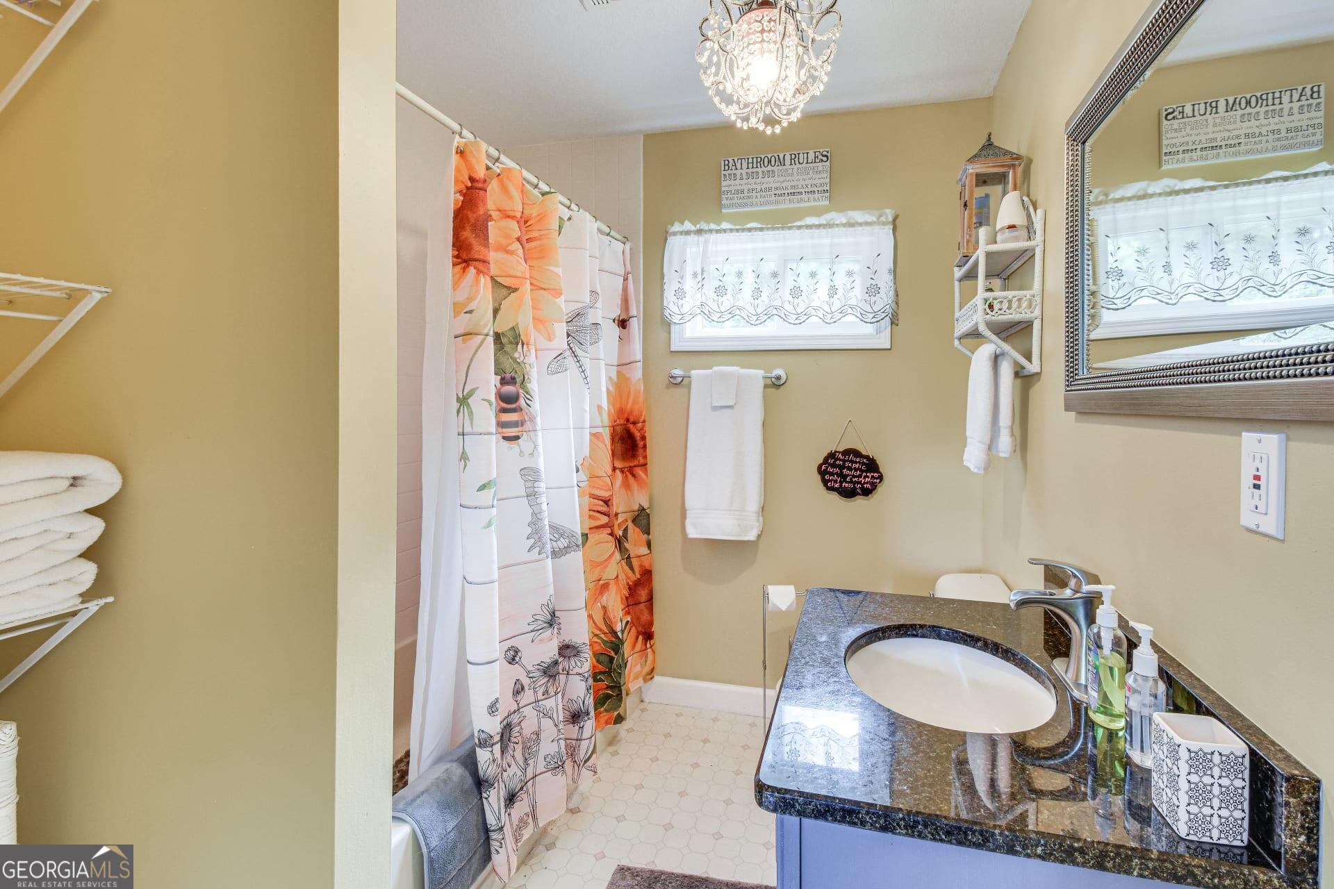 1912 Bearmeat Village Road Hiawassee, GA 30546 - Photo 14 of 23 a bathroom with a granite countertop sink and a mirror