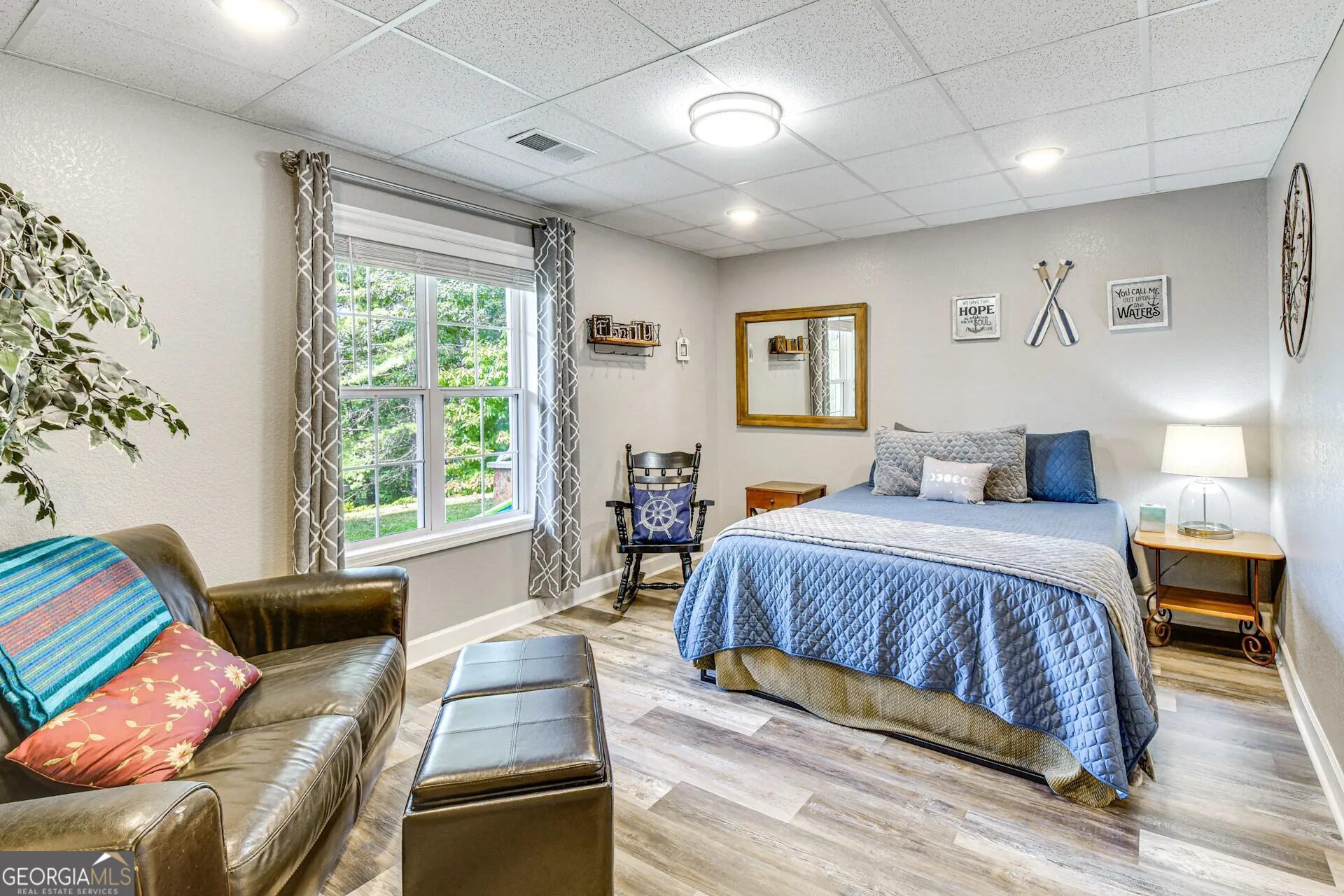 1912 Bearmeat Village Road Hiawassee, GA 30546 - Photo 15 of 23 a bedroom with a bed and wooden floor