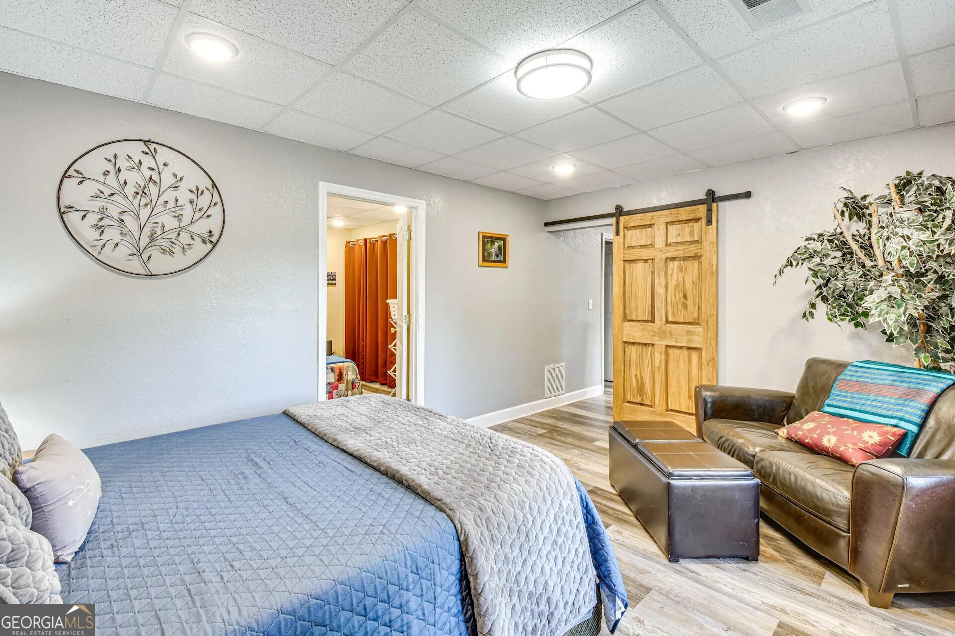 1912 Bearmeat Village Road Hiawassee, GA 30546 - Photo 16 of 23 a bedroom with a bed and wooden floor