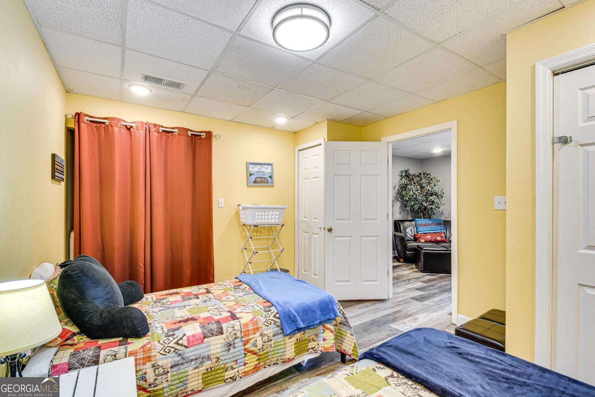 1912 Bearmeat Village Road Hiawassee, GA 30546 - Photo 19 of 23 a bedroom with a bed and a dresser next to a window