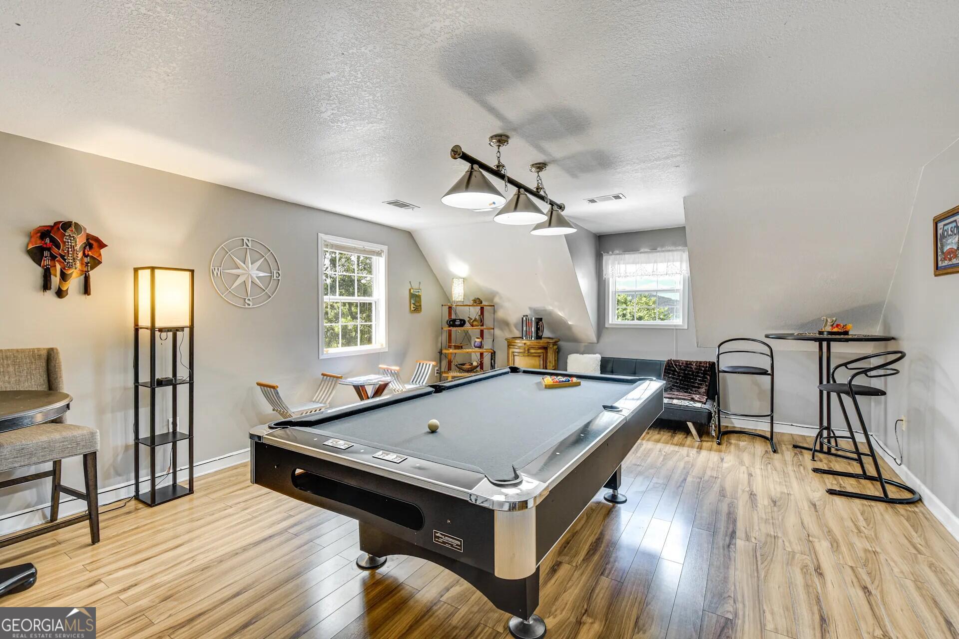 1912 Bearmeat Village Road Hiawassee, GA 30546 - Photo 22 of 23 a living room with a table chairs and a wooden floor