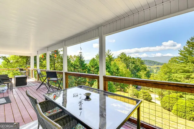 a view of balcony with wooden floor and outdoor seating