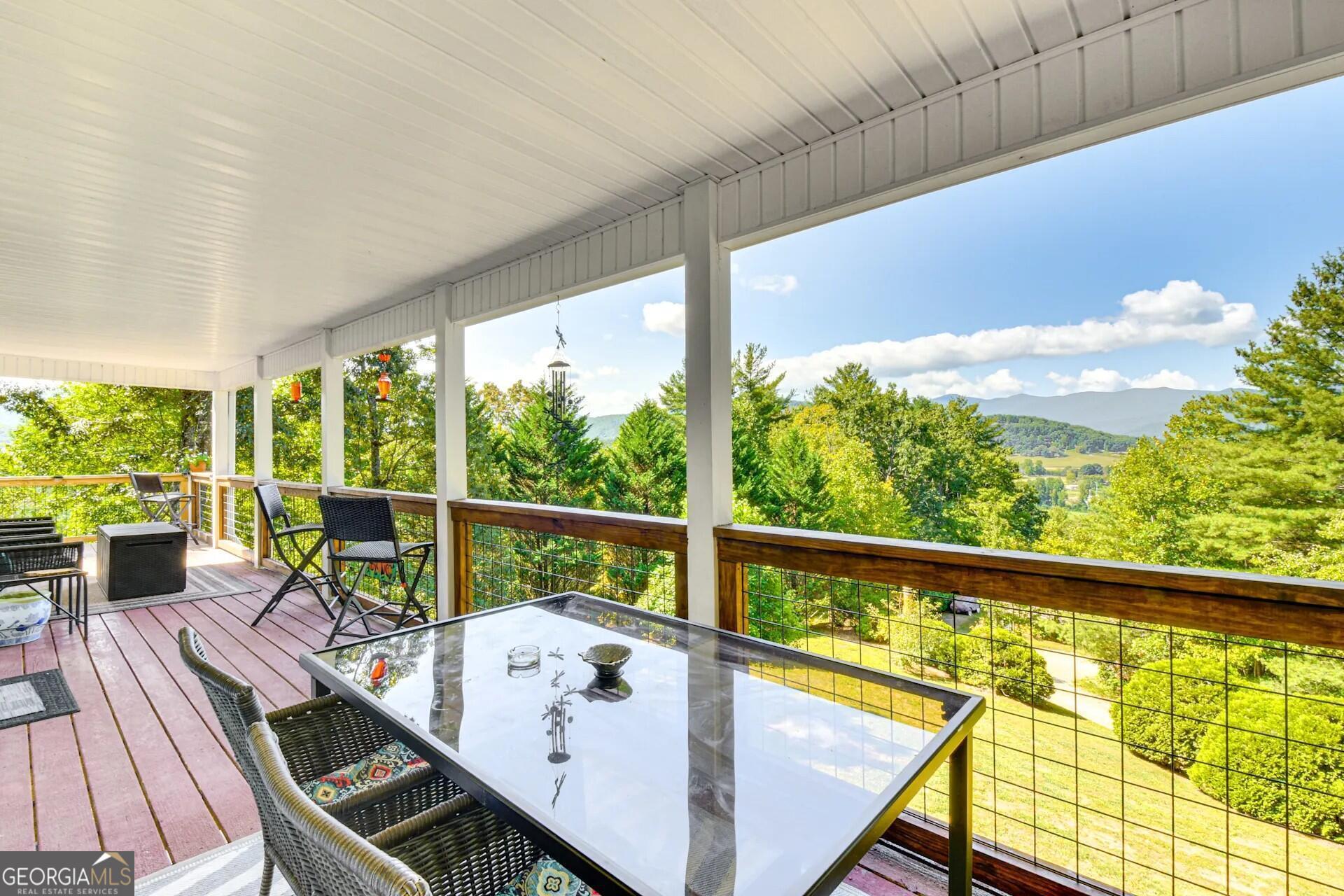 1912 Bearmeat Village Road Hiawassee, GA 30546 - Photo 3 of 23 a view of balcony with wooden floor and outdoor seating