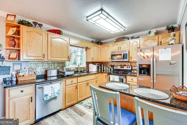 a kitchen with stainless steel appliances a sink stove and cabinets
