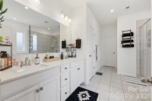 a spacious bathroom with mirror and shower
