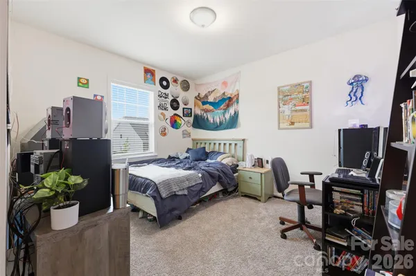 a bedroom with a bed table and a couch