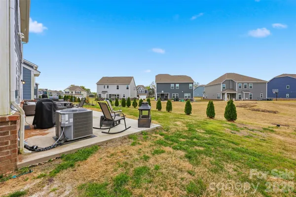 a view of a house with swimming pool and sitting area