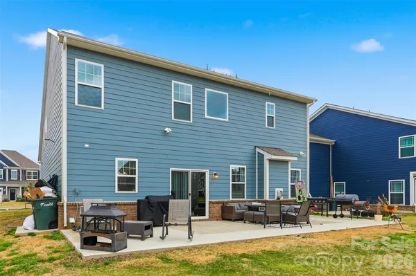 a backyard of a house with outdoor seating