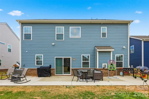 a view of house with yard outdoor seating area and furniture