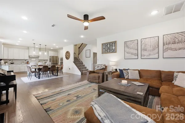 a living room with furniture and kitchen view