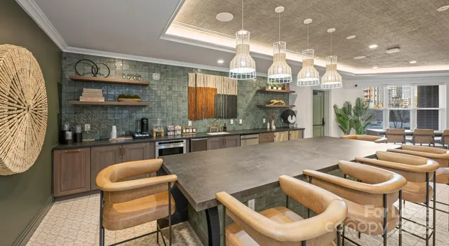 a kitchen with a dining table and chairs
