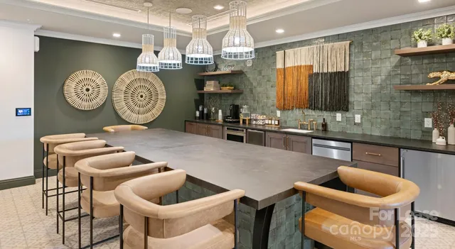 a kitchen with kitchen island granite countertop a sink stove and cabinets